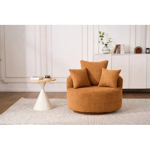 Modern round tan textured armchair with matching pillows, plush fabric, and relaxed fit