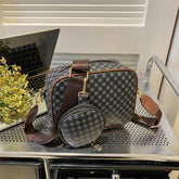 Black and gray geometric pattern crossbody bag with brown strap, matching coin pouch, and gold hardware.