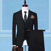 Classic black three-piece suit with notched lapel, white dress shirt, slim fit, and tie on mannequin