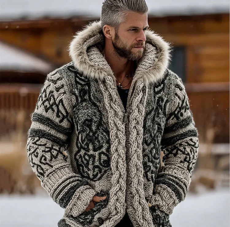 Man wearing chunky knit sweater with fur-trimmed hood, black and grey pattern, relaxed fit