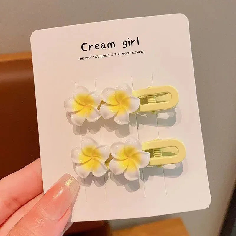 Set of yellow and white flower-shaped hair clips on display card, cute fashion accessory
