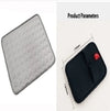 Gray quilted cushion with circular texture, black neoprene case with red tab, 170x130mm