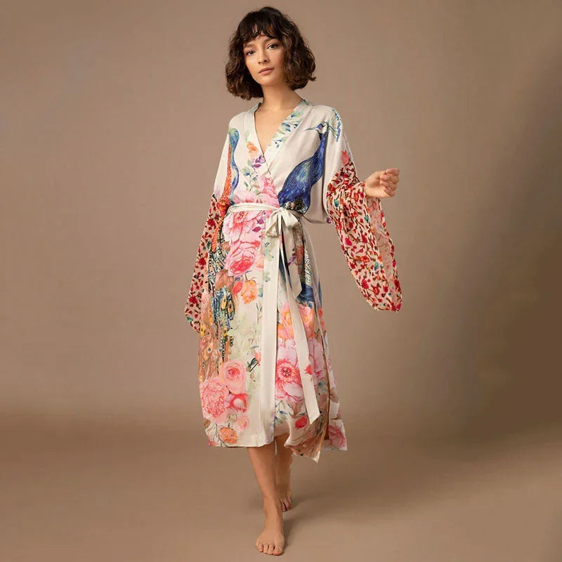 Woman wearing a floral kimono robe with colorful prints and loose, flowy fit