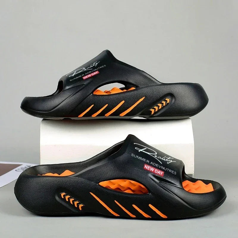 Black and orange futuristic slip-on sandals with cutout details and cushioned sole