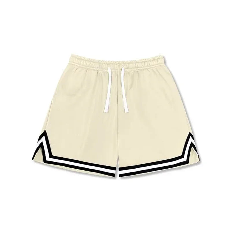 Cream athletic shorts with black zigzag trim, drawstring waist, and relaxed fit