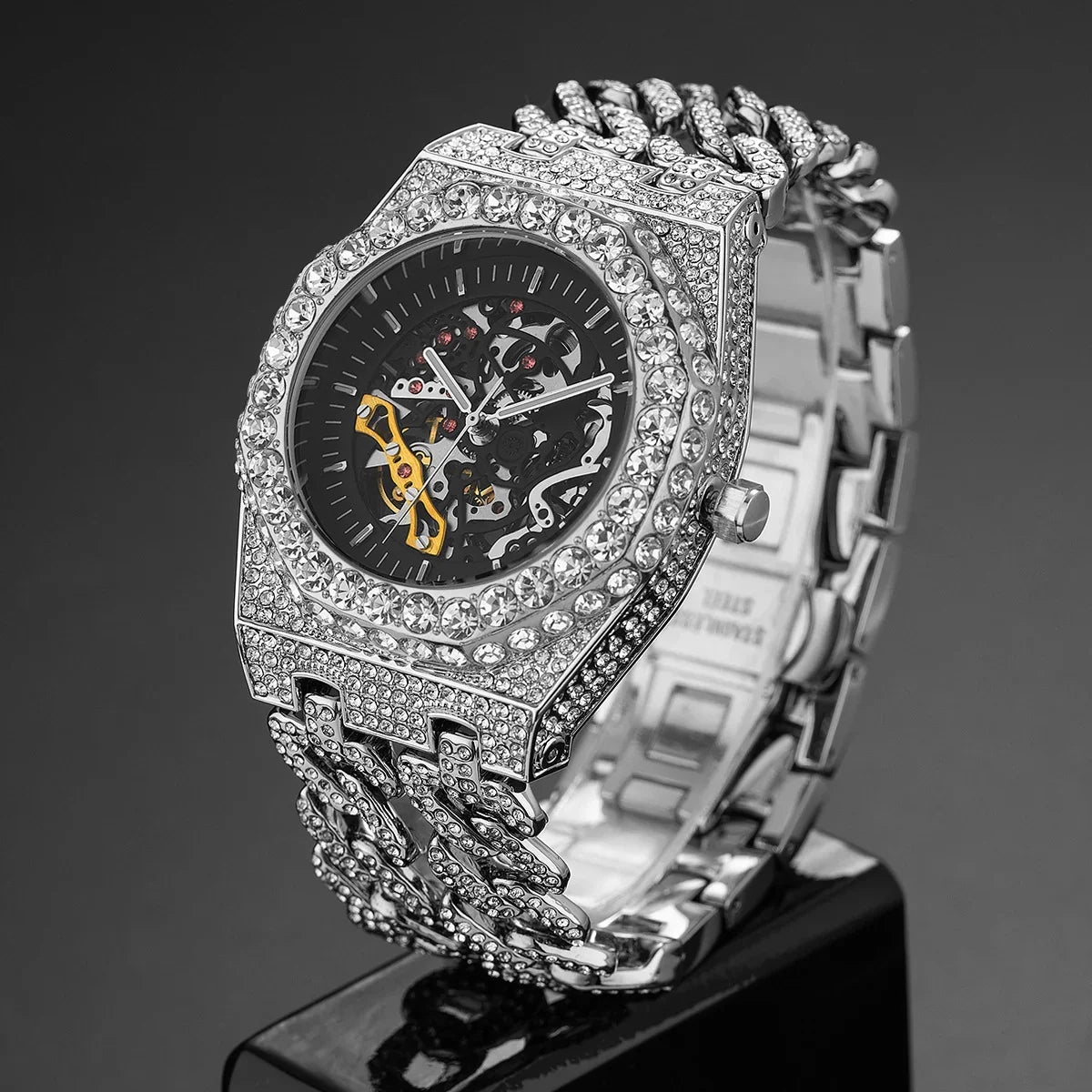 Silver iced-out skeleton watch with crystal-studded link band and openwork dial