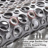 Close-up of gray rubber mat with large suction cups and water droplets, non-slip design