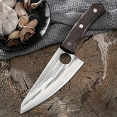 Stainless steel chef knife with dark wooden handle on rustic wood surface, next to garlic cloves