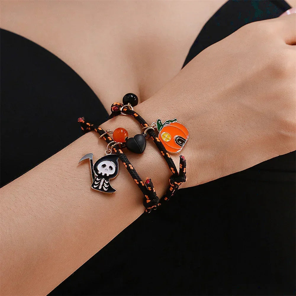 Black and orange rope bracelet with Halloween-themed charms, worn on wrist, streetwear accessory