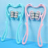 Blue and pink plastic roller massagers with ergonomic handles and gray wheels on a blue background