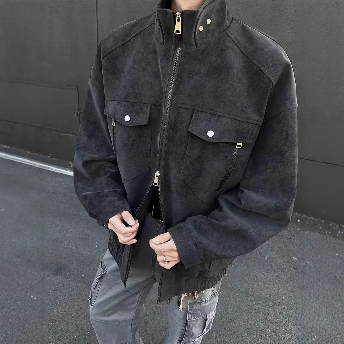 Black suede streetwear jacket with front pockets, relaxed fit, high collar, and zipper closure