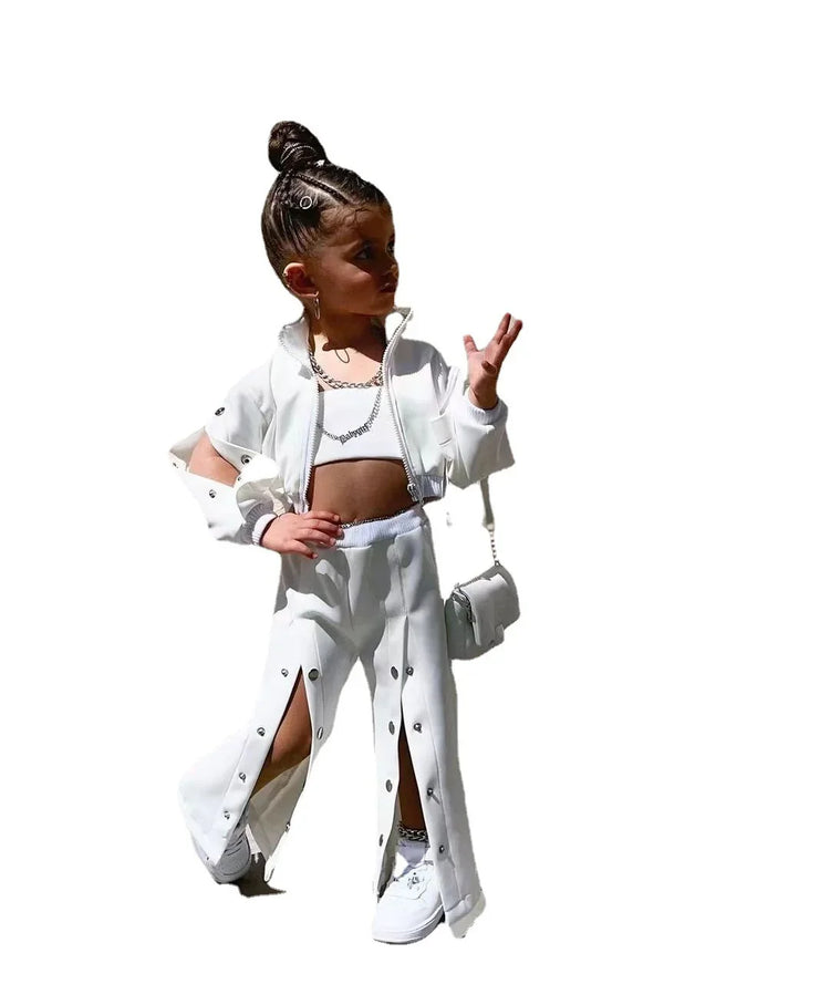 Girl wearing white streetwear set with snap button pants, crop top, and matching jacket