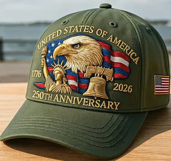 Olive green baseball cap with embroidered American flag, bald eagle, Liberty Bell, and Statue of Liberty, celebrating the 250th anniversary.