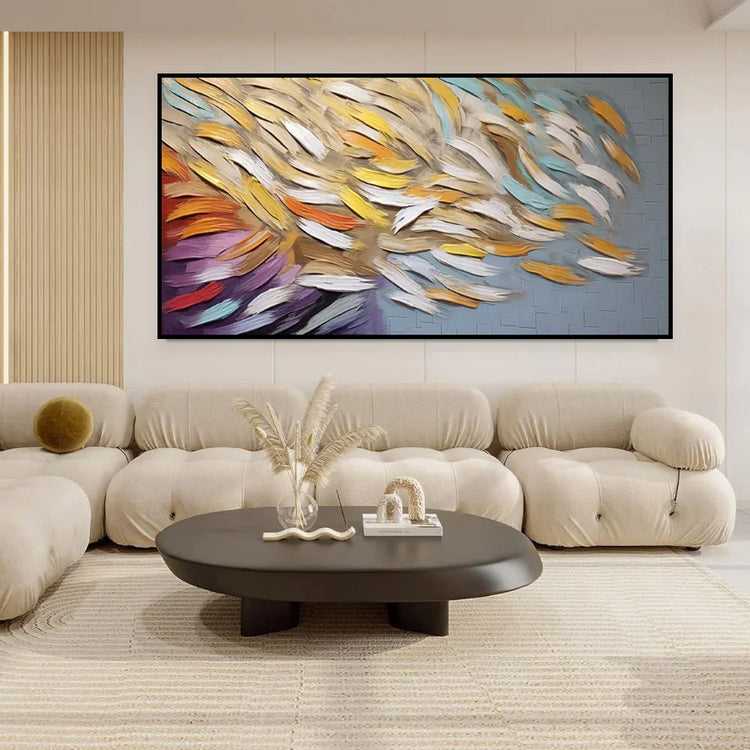 Modern living room with tufted beige sofa, cream fabric, and abstract colorful wall art
