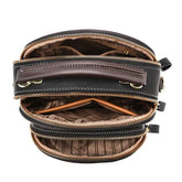 Black and brown leather crossbody bag with multiple zippered compartments and striped lining