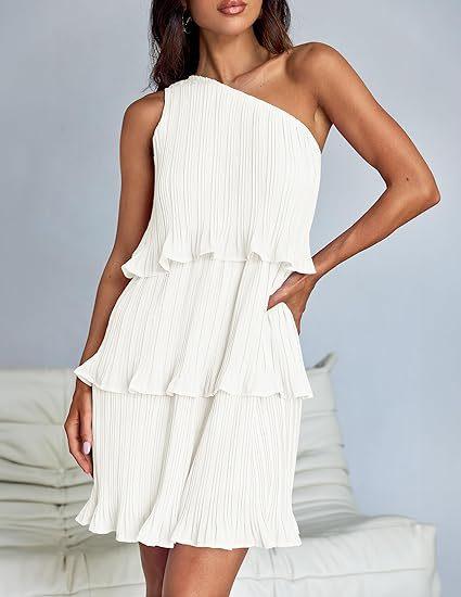 Woman wearing a white pleated one-shoulder ruffle mini dress, relaxed fit.