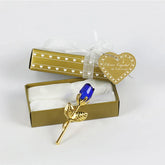 Gold and blue crystal rose ornament in a gold gift box with heart-shaped tag