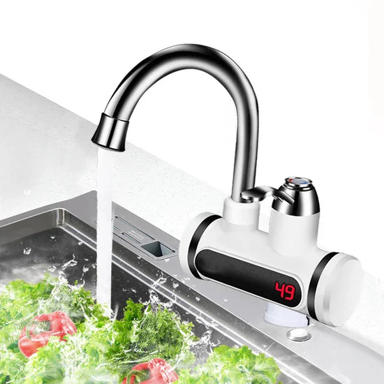 Modern stainless steel kitchen faucet with digital temperature display and running water over fresh vegetables in a sink
