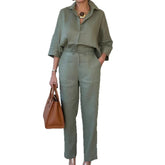 Woman wearing sage green loose-fit shirt and high-waisted pants set, minimalist style