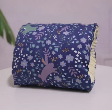 Blue floral-patterned blanket with cartoon bunny design, soft plush material, folded neatly