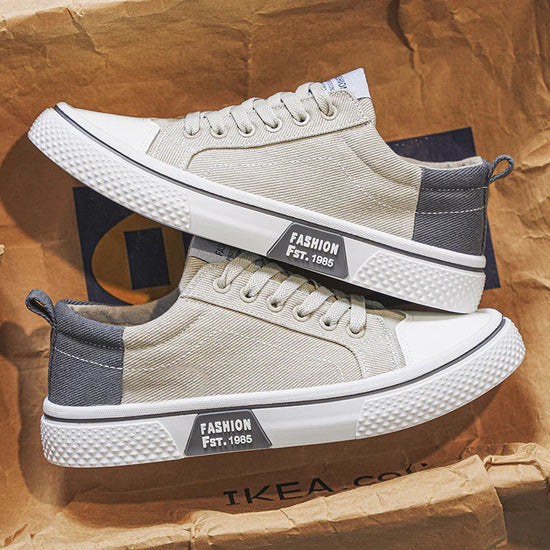 Beige canvas lace-up sneakers with grey accents and rubber soles, casual streetwear style