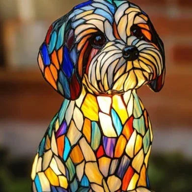 Colorful stained glass dog lamp with mosaic pattern, illuminated indoors.