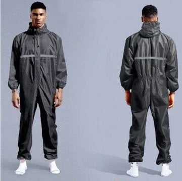 Man wearing a loose-fit black reflective one-piece jumpsuit with hood and elastic cuffs