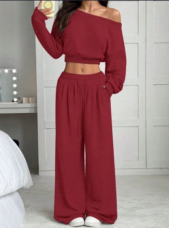Woman wearing a red off-shoulder crop top and wide-leg lounge pants set, relaxed fit.