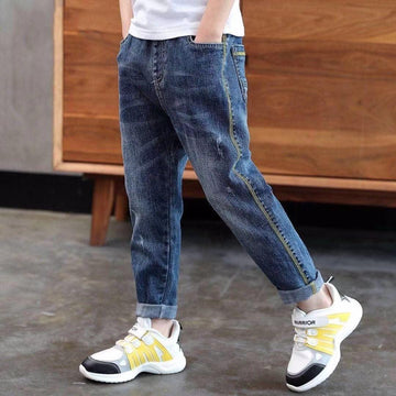 Relaxed fit blue denim jeans with rolled cuffs and yellow contrast stitching, streetwear style