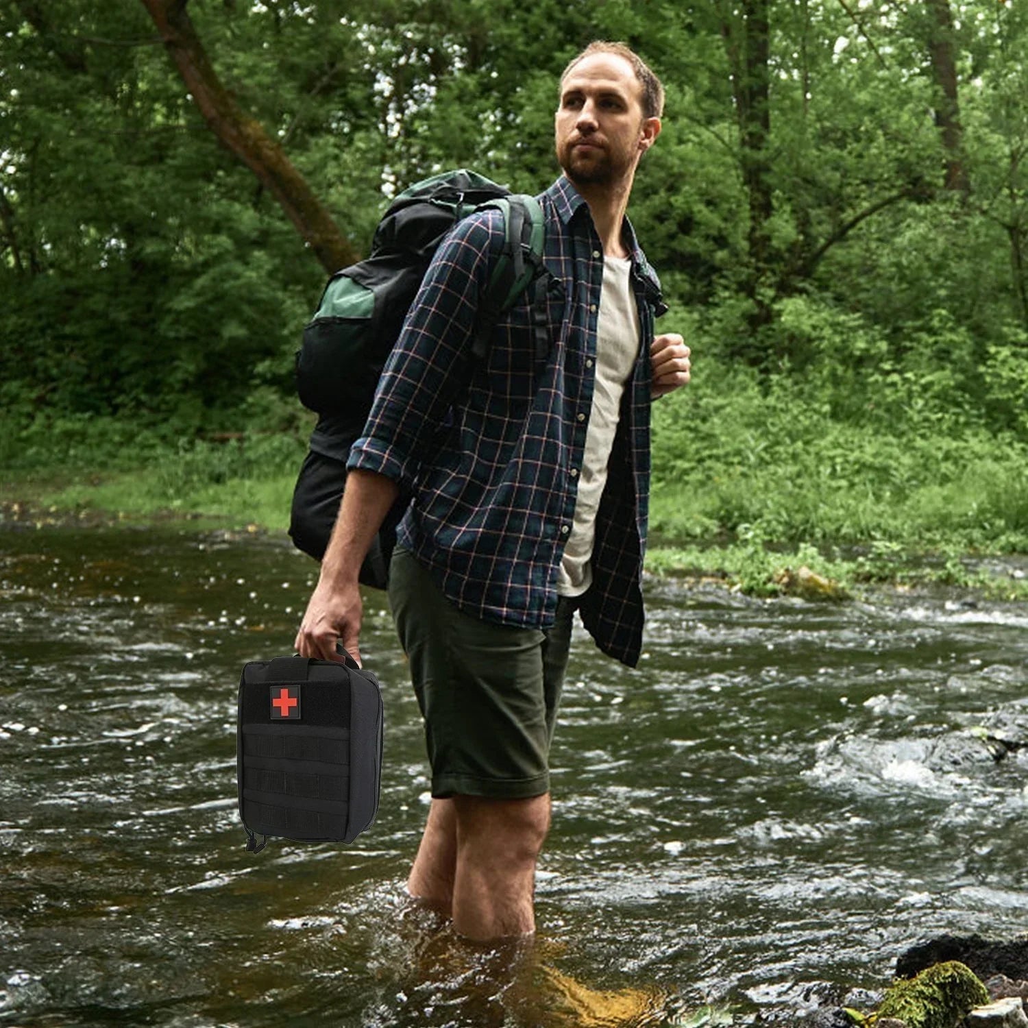 Man in plaid shirt and green shorts hiking with backpack, crossing a river in outdoor adventurewear