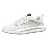 White low-top sneaker with mesh and textured panels, lace-up closure, and chunky sole.
