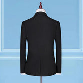 Black slim-fit blazer with long sleeves, displayed on a mannequin against a blue background