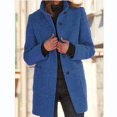 Woman wearing a blue wool coat, tailored fit, with large buttons and front pockets