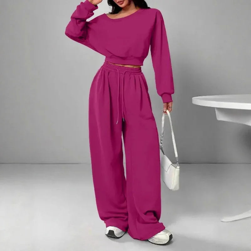 Woman wearing magenta oversized lounge set with long sleeves and wide leg pants, casual fit
