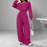 Woman wearing magenta oversized lounge set with long sleeves and wide leg pants, casual fit