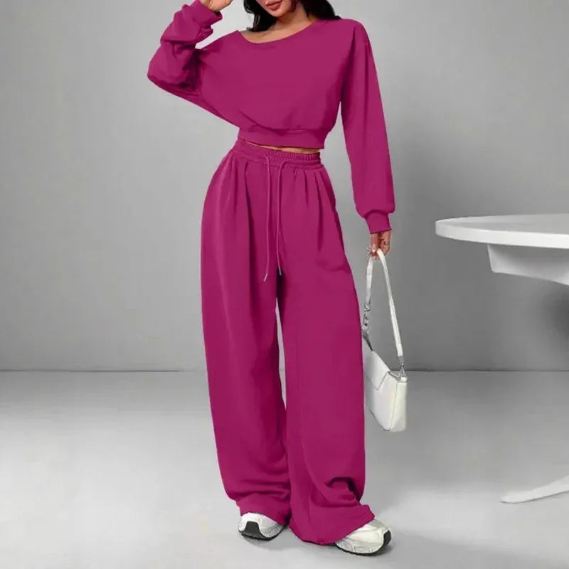 Woman wearing magenta oversized lounge set with long sleeves and wide leg pants, casual fit