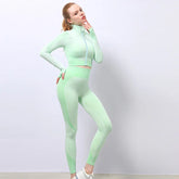 Woman in mint green seamless textured athletic set, zip-up crop top and high-waisted leggings