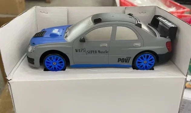 No clothing featured; image shows a grey and blue toy car with blue wheels in a box.
