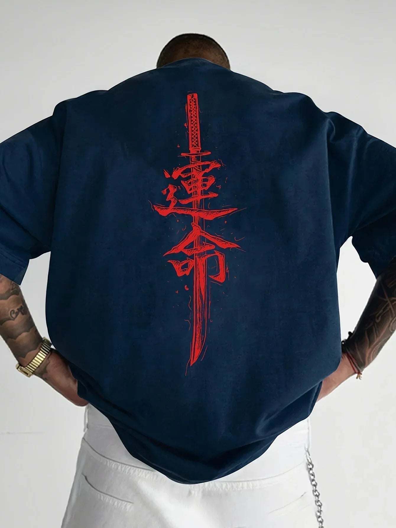 Oversized navy blue streetwear t-shirt with bold red katana and kanji back graphic, relaxed fit