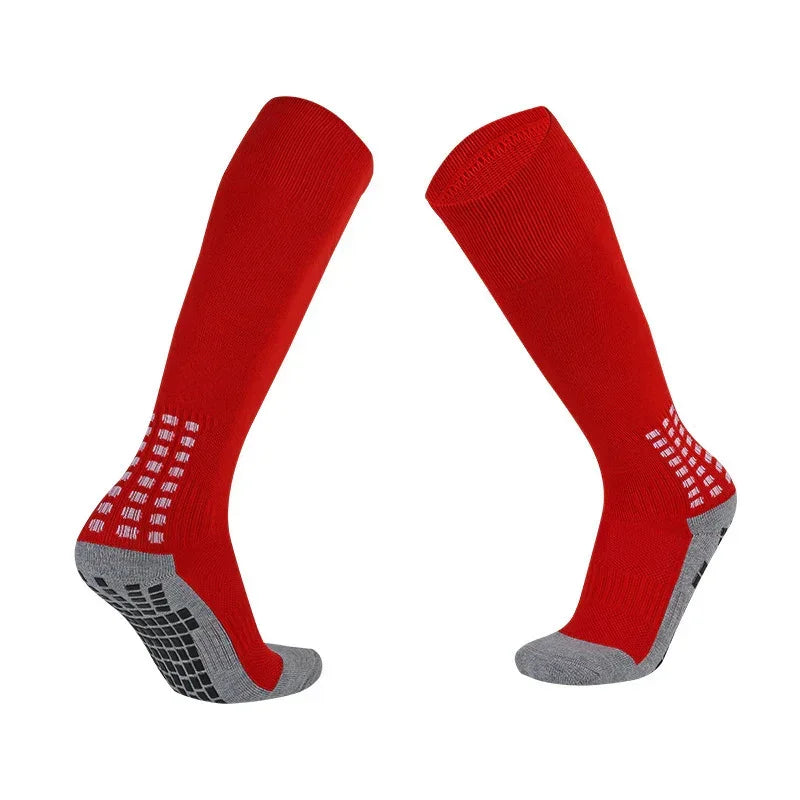 Red knee-high athletic socks with gray cushioned soles and anti-slip grip pattern