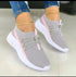 Lightweight grey mesh sneakers with pink accents, white soles, and slim fit design