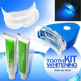 LED teeth whitening kit with mouth tray, two gel tubes, and blue light device for home dental care