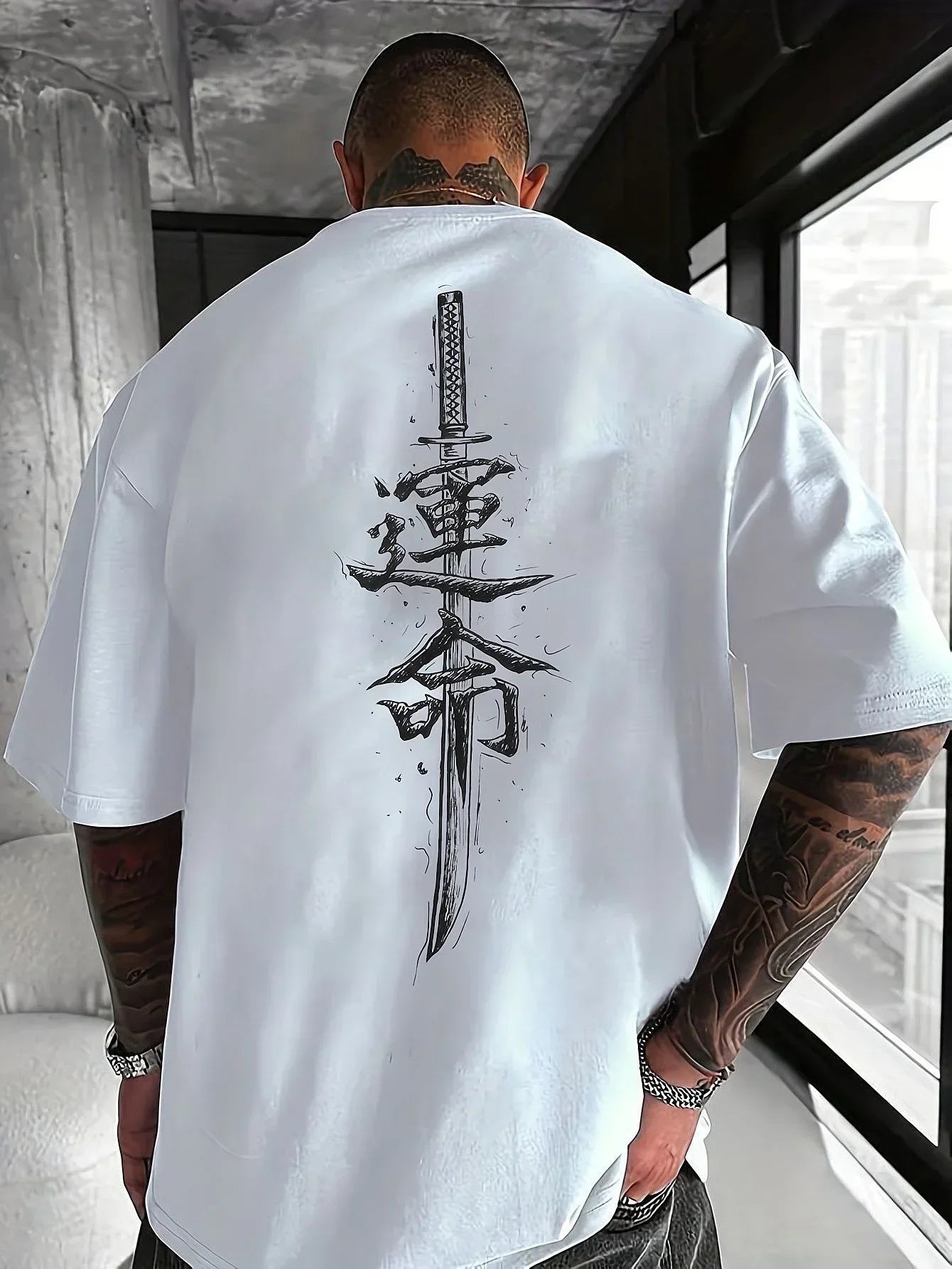 Oversized white streetwear t-shirt with sword and Asian character graphic on back, relaxed fit.