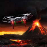 Silver quadcopter drone with LED lights flies near erupting volcano and flowing lava at sunset.
