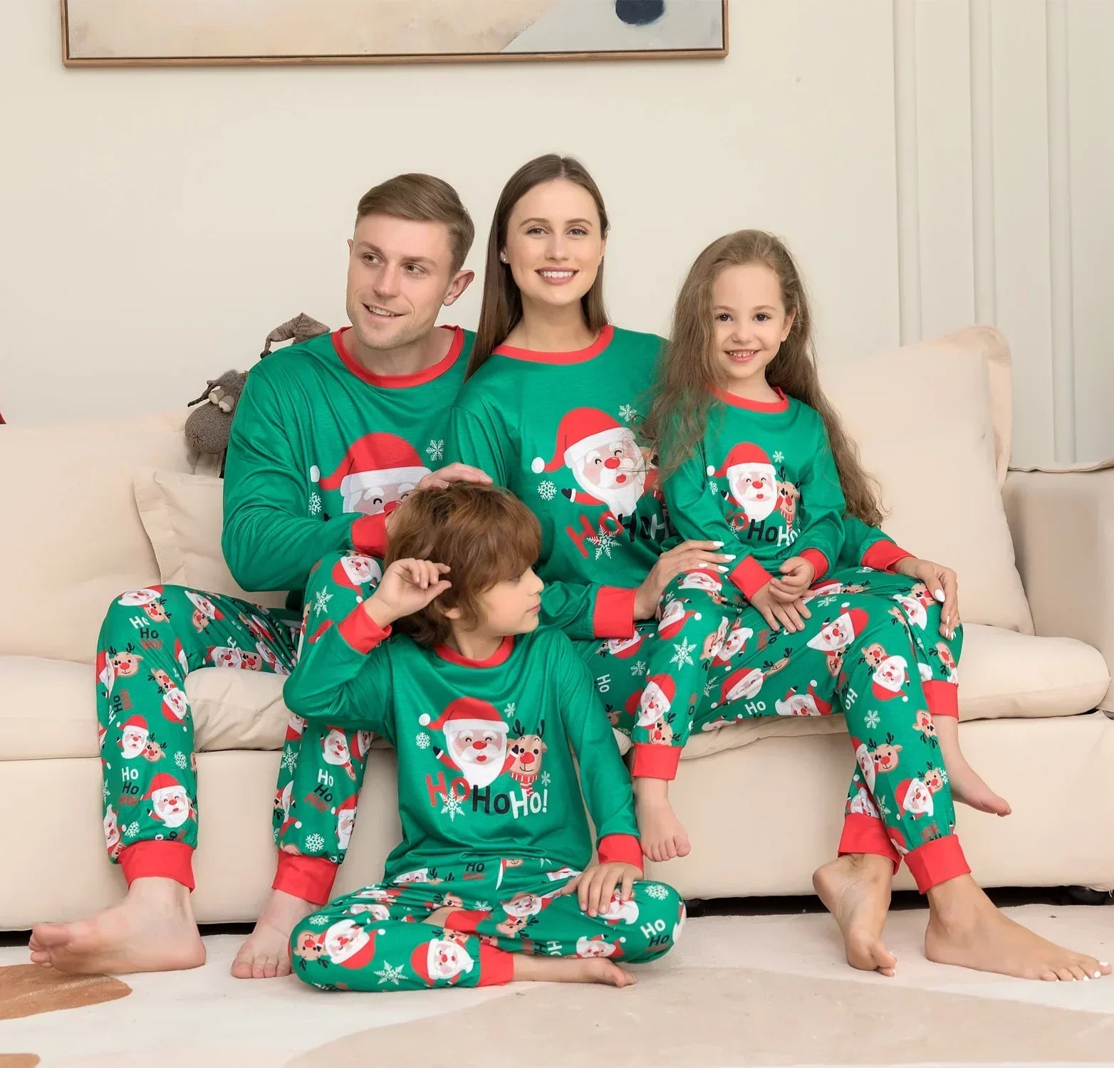 Family wearing matching green Christmas pajamas with Santa Claus print, relaxed fit, red trim