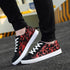 Black and red graphic print low-top sneakers with white soles and laces, casual streetwear style