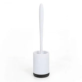 Modern white toilet brush with sleek plastic handle and minimalist holder on white background.