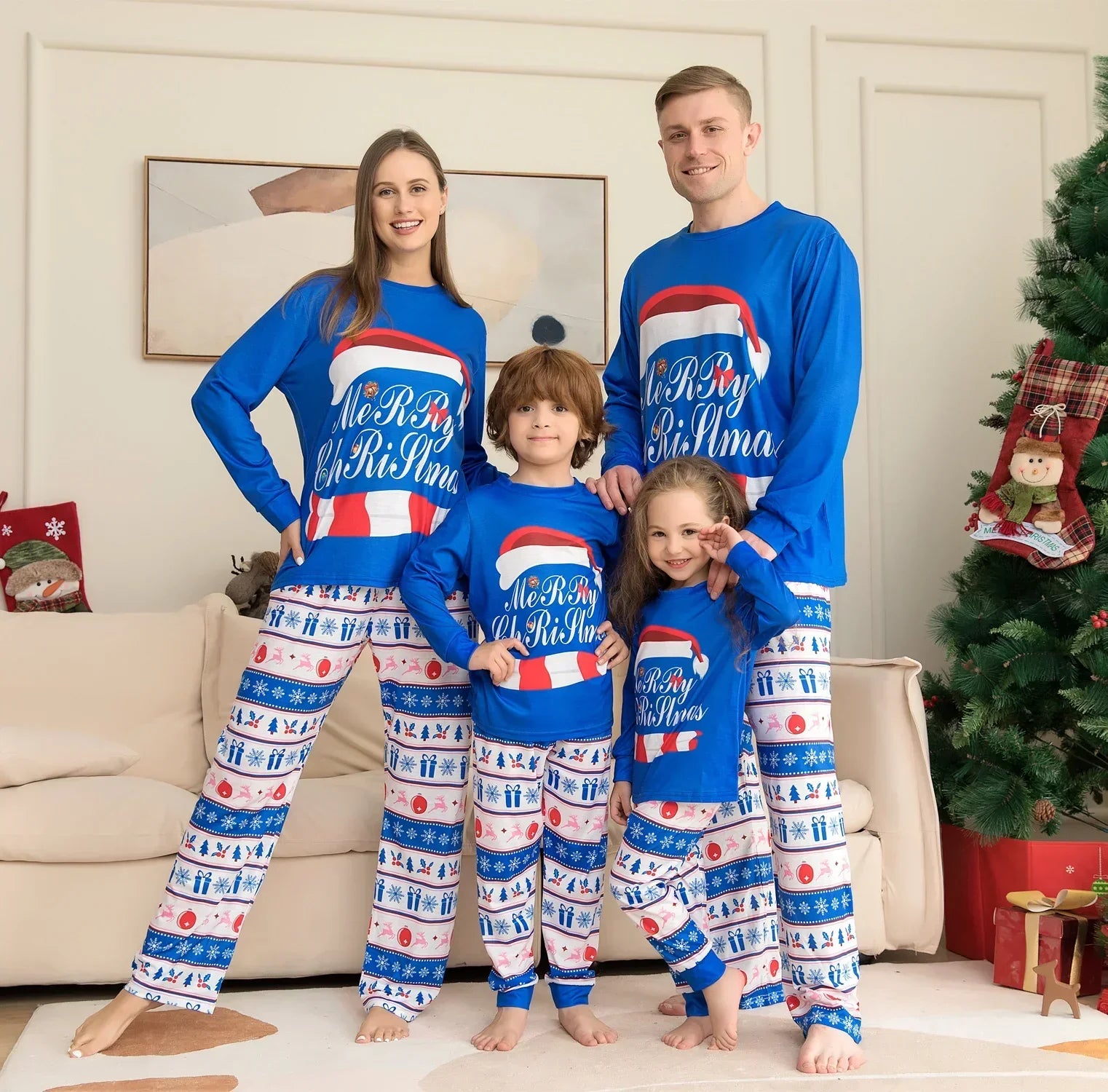 Family wearing matching blue Christmas pajama sets with festive print and relaxed fit.