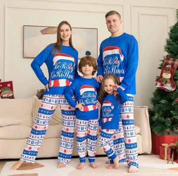 Family wearing matching blue Christmas pajama sets with festive print and relaxed fit.