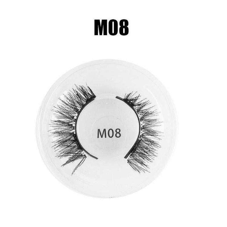 Voluminous black faux mink false eyelashes in round plastic case, style M08.